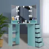 A makeup vanity with lights and drawers, set against a blue wall with a plant. Podgląd zdjęcia produktu