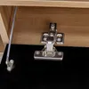 A close-up view of a cabinet hinge and a metal support rod attached to a wooden surface and a black surface. Anteprima dell’immagine prodotto