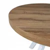 A close-up view of a round table with a wood-grain finish and white legs. Náhled obrázku produktu