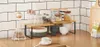 A kitchen counter with a 2-tier shelf unit holding various kitchen items like glasses, jars, and bowls. Produktbild-Vorschau