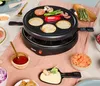 A raclette grill set up for a meal, with various ingredients and serving dishes around it. Anteprima dell’immagine prodotto