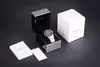 An Emporio Armani watch is displayed in its open box, alongside its outer packaging and documentation, on a dark background. Voir les images du produit