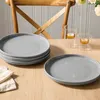 A table setting with plates and candle holders. Produktbild-Vorschau
