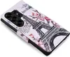 A flip-style phone case with an Eiffel Tower and floral design. Produktbild-Vorschau