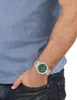 A person wearing a watch and jeans. Produktbild-Vorschau