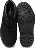 A pair of black Timberland boots, one shown from the top and the other from the sole.