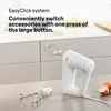 A white hand mixer with attachments and eggs on a countertop. Produktbild-Vorschau