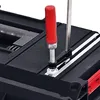 A close-up view of a tool box with a clamp and measuring tape. Náhled obrázku produktu