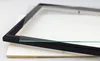A black picture frame and a piece of glass are placed on a white surface. Produktbild-Vorschau