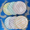 A set of striped plates arranged on a blue surface with sand. Voir les images du produit