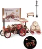A 3D mechanical model of a steam engine with a trailer, a lamppost, and a bench, presented on a white background. The steam engine model is detailed with gears and wheels, and has a light illuminating from its chimney. A smaller inset image shows the steam Produktbild-Vorschau