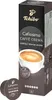 A box of Tchibo Cafissimo Caffè Crema coffee capsules with two loose capsules in the foreground. Produktbild-Vorschau