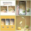 A collage of images showing a dinosaur-shaped desk lamp with different lighting modes and brightness adjustments. Produktbild-Vorschau