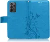 A blue flip case for a smartphone, with a floral and butterfly embossed design. Produktbild-Vorschau