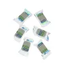 A group of individually wrapped dishwasher tabs arranged on a white background. Podgląd zdjęcia produktu