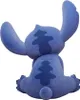 A blue Stitch figurine seen from the back, sitting down with its arms raised. Produktbild-Vorschau