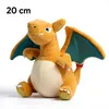 A plush toy of a dragon-like creature, likely a Pokemon character, is shown sitting against a white background. Produktbild-Vorschau