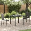 A patio set with two chairs and a table on a brick-paved patio, surrounded by greenery. Náhľad obrázku produktu
