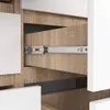 A close-up view of a drawer slide mechanism within a wooden cabinet. Produktbild-Vorschau