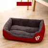 A red and gray dog bed is placed on a wooden floor. Anteprima dell’immagine prodotto
