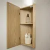 An open wooden cabinet with bathroom products inside. Voir les images du produit