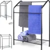 A black metal towel rack with towels draped and rolled on it, shown from multiple angles. Anteprima dell’immagine prodotto