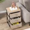 A bedside table with three fabric drawers next to a sofa. Podgląd zdjęcia produktu