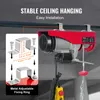 A red electric hoist is mounted on a ceiling beam, with a diagram showing installation details. Náhľad obrázku produktu