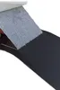 A close-up view of a piece of black faux leather being peeled back from a gray fabric material. Produktbild-Vorschau