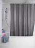 A grey shower curtain hanging in a bathtub. Produktbild-Vorschau