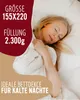 A woman sleeping comfortably under a duvet. Produktbild-Vorschau