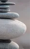A close-up of a stack of smooth, grey stones. Produktbild-Vorschau