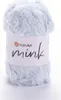 A ball of light blue fluffy yarn with a white label wrapped around it. Produktbild-Vorschau
