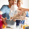 A father and son are preparing breakfast, pouring cereal into a bowl. Voir les images du produit