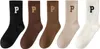 Five pairs of socks with the letter 'P' on them, arranged in a row. Podgląd zdjęcia produktu