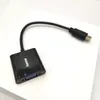 A black video adapter with a flexible cable and connectors is placed on a white surface. Anteprima dell’immagine prodotto