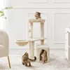 Three cats interact with a beige cat tree in a well-lit room with white walls and a patterned rug. Produktbild-Vorschau