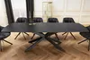 A dining table with chairs in a well-lit room. Produktbild-Vorschau