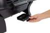 A hand is shown pulling out a small black tray from a grill. Produktbild-Vorschau