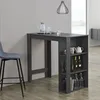 A dark gray bar table with shelves is shown next to a gray bar stool, with various bottles and glasses on the shelves and table. Produktbild-Vorschau