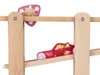 A close-up of a wooden toy car race track with a red car and a pink accessory. Anteprima dell’immagine prodotto