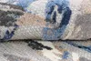 A close-up view of a folded rug with a modern abstract pattern. Náhľad obrázku produktu