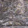 A close-up view of a fabric with a paisley pattern. Produktbild-Vorschau