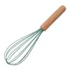 A kitchen whisk with a wooden handle and green silicone wires is shown against a white background. Produktbild-Vorschau