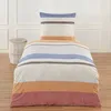 A bedding set with a pillow and duvet cover is displayed on a bed in a room. Produktbild-Vorschau