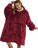A woman wearing a burgundy blanket hoodie. Produktbild-Vorschau