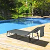 A gray lounge chair is placed on a wooden deck next to a swimming pool. Náhled obrázku produktu