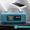 A blue portable power bank and compressor is shown charging a white smartphone. The product has a digital display and buttons. Produktbild-Vorschau