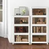 Two stacks of white storage cabinets with clear doors, filled with books and other items, are placed against a white wall. Náhľad obrázku produktu