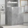 A bathroom storage cabinet with towels on shelves and a ladder with towels in the background. Produktbild-Vorschau